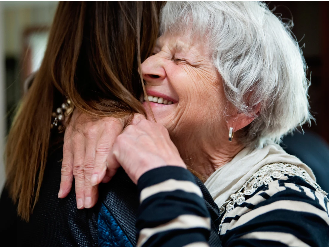 A compassionate medical social worker providing emotional support to a senior receiving healthcare guidance in Alexandria City, VA.