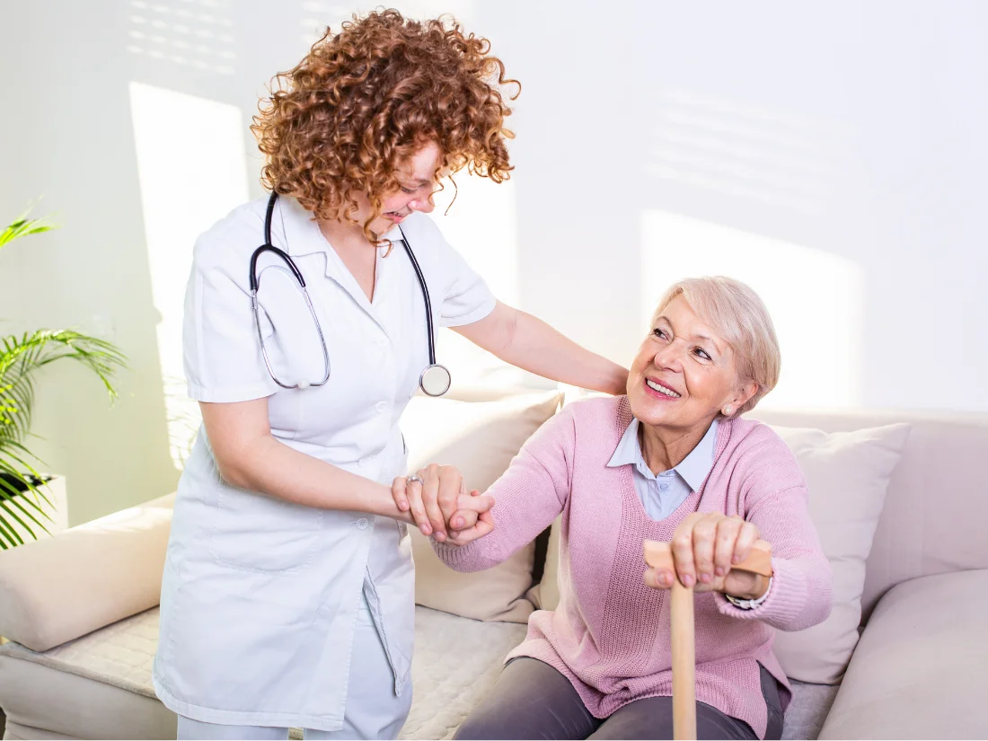A compassionate caregiver assisting a senior while demonstrating dependable home health care services in Alexandria City, VA.